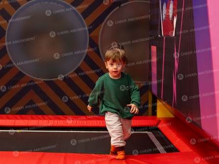 Indoor trampoline park main jumping area with safety padding